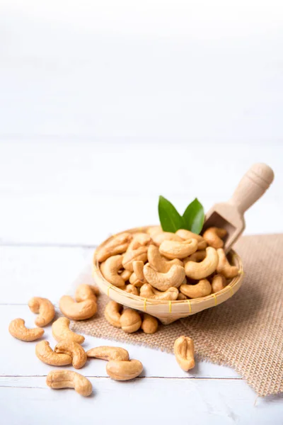 Anacardi Con Foglie Verdi Cesto Cucchiaio Isolato Sfondo Legno Bianco — Foto Stock