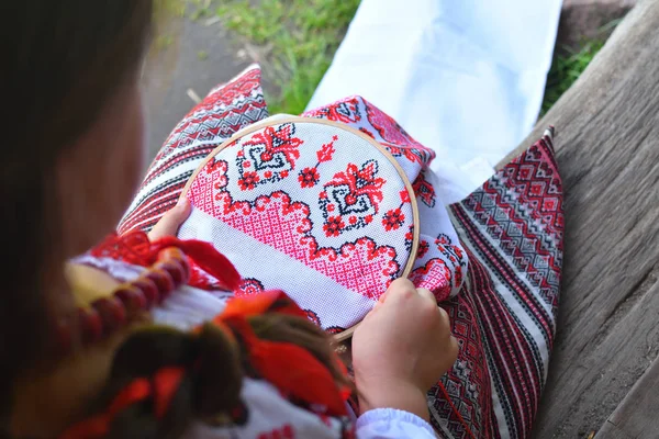 Meisje borduurwerk Rushnik. handen van meisje vrouw vrouw in Oekraïense traditionele shirt naaien borduurwerk patroon in borduurwerk frame. — Stockfoto