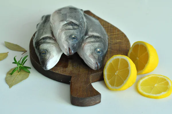 Fresh fish with lemon and Rosemary on wooden board. mediterranean diet . healthy food — Stock Photo, Image