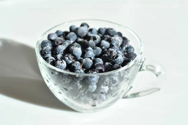Blueberries in a glass cup on white background. — Stock Photo, Image