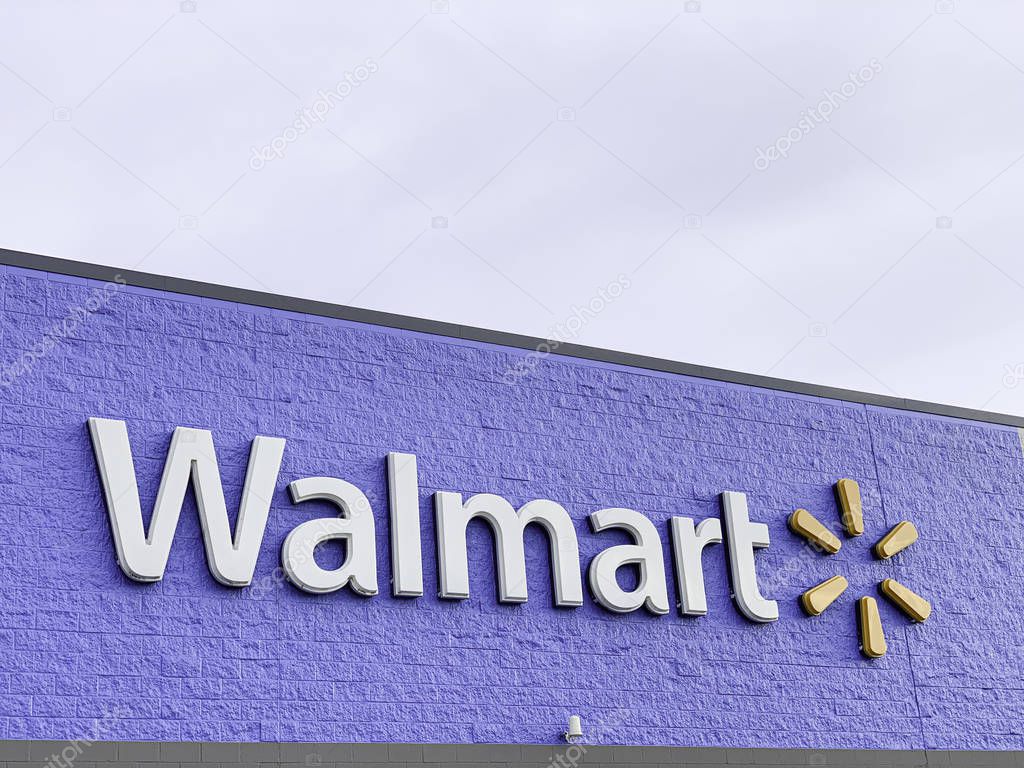Vidalia, Georgia / USA - June 13, 2019: The prominent lighted 3D brand and logo of Walmart on the top portion of its big box store facade in Vidalia, Georgia, USA.