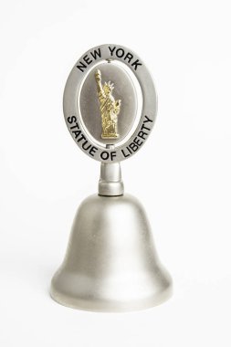 Vidalia, Georgia / USA - June 14, 2019: An illustrative close-up studio product shot of a commemorative collectible tiny gift shop bell for tourists featuring New York City's iconic Statue of Liberty. clipart