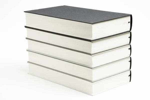 Um conjunto de livros de tecido monocromático ordenadamente empilhados — Fotografia de Stock