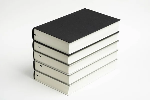 A Set of Neatly Stacked Monochromatic Cloth Bound Books — стоковое фото