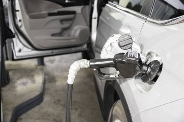 Filling A Vehicle���s Fuel Tank At A Gas Station clipart