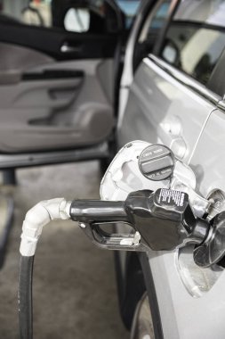 Filling A Vehicle���s Fuel Tank At A Gas Station clipart