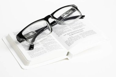 White Pocket Bible With Reading Glasses clipart