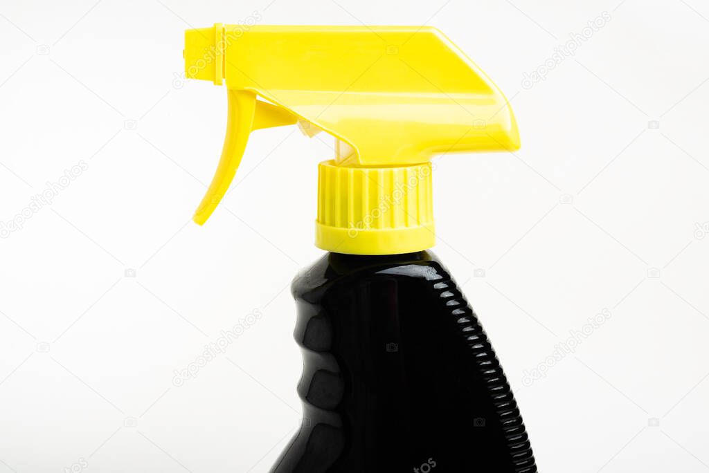 A close-up of the top portion of a black and yellow liquid spray plastic dispenser bottle set on a plain white background.