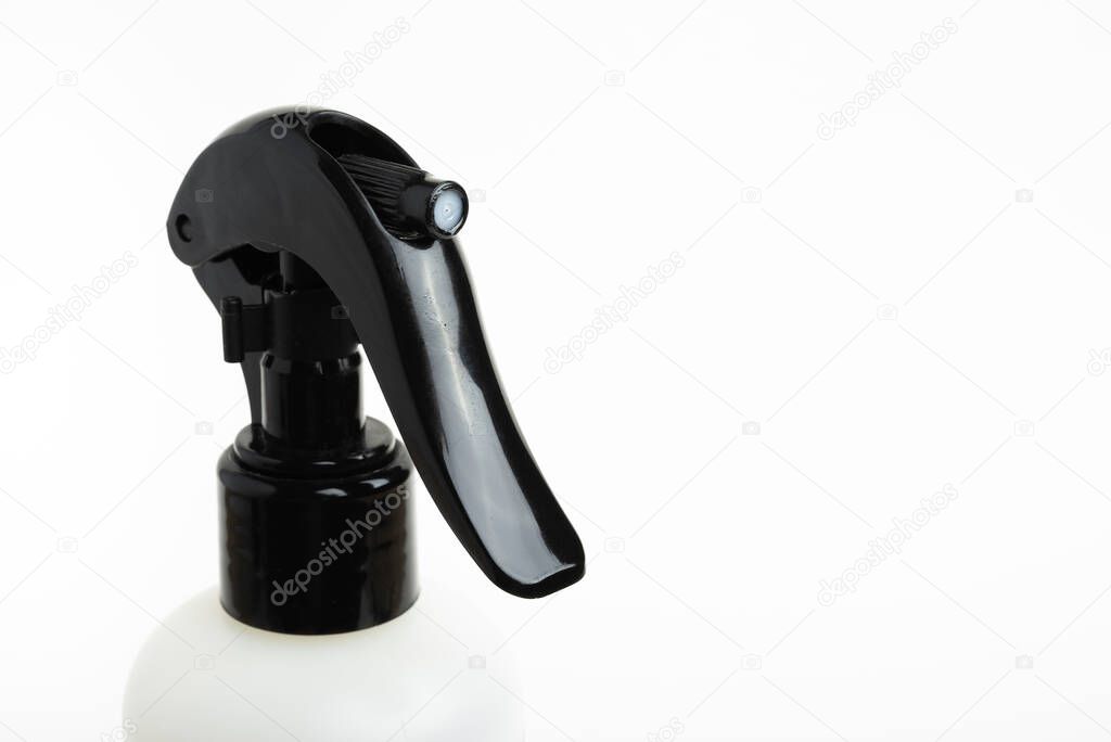 A close-up of the top portion of a black and white liquid spray plastic dispenser bottle set on a plain white background.