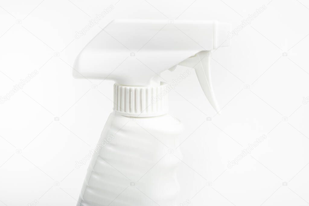 A close-up of the top portion of an all-white liquid spray plastic dispenser bottle set on a plain white background.