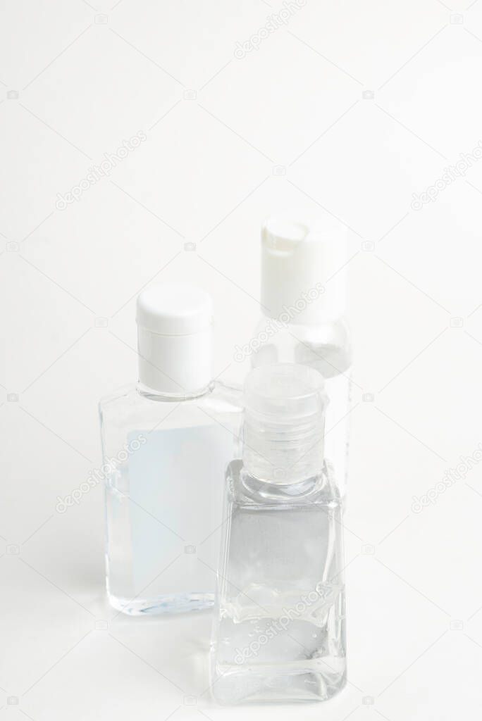 A product shot of three generic pocket-size transparent hand sanitizer plastic dispenser bottles set on a plain white background.