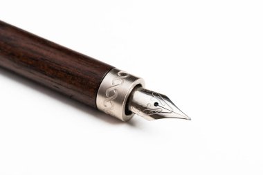 A close-up product shot of the wooden barrel and writing tip of a classic fountain pen set on plain white background. clipart