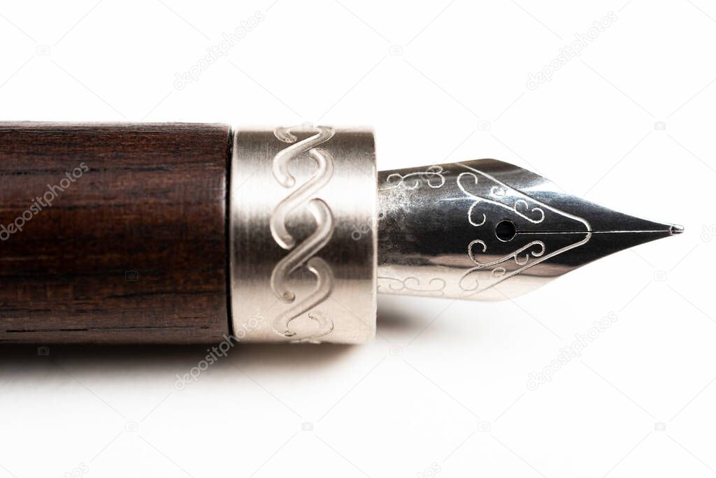 A close-up product shot of the wooden barrel and writing tip of a classic fountain pen set on plain white background.