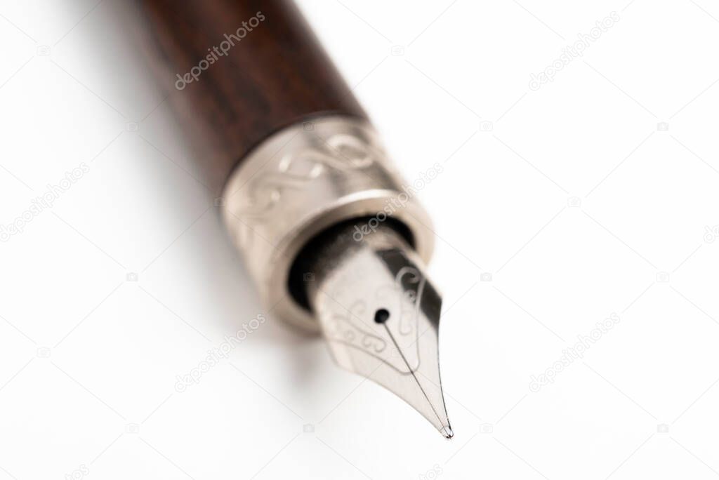 A close-up product shot of the wooden barrel and writing tip of a classic fountain pen set on plain white background.