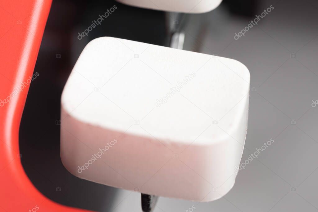 An extreme close-up or macro shot of a plastic keyboard key from a manual typewriter with shallow depth of field and selective focus.