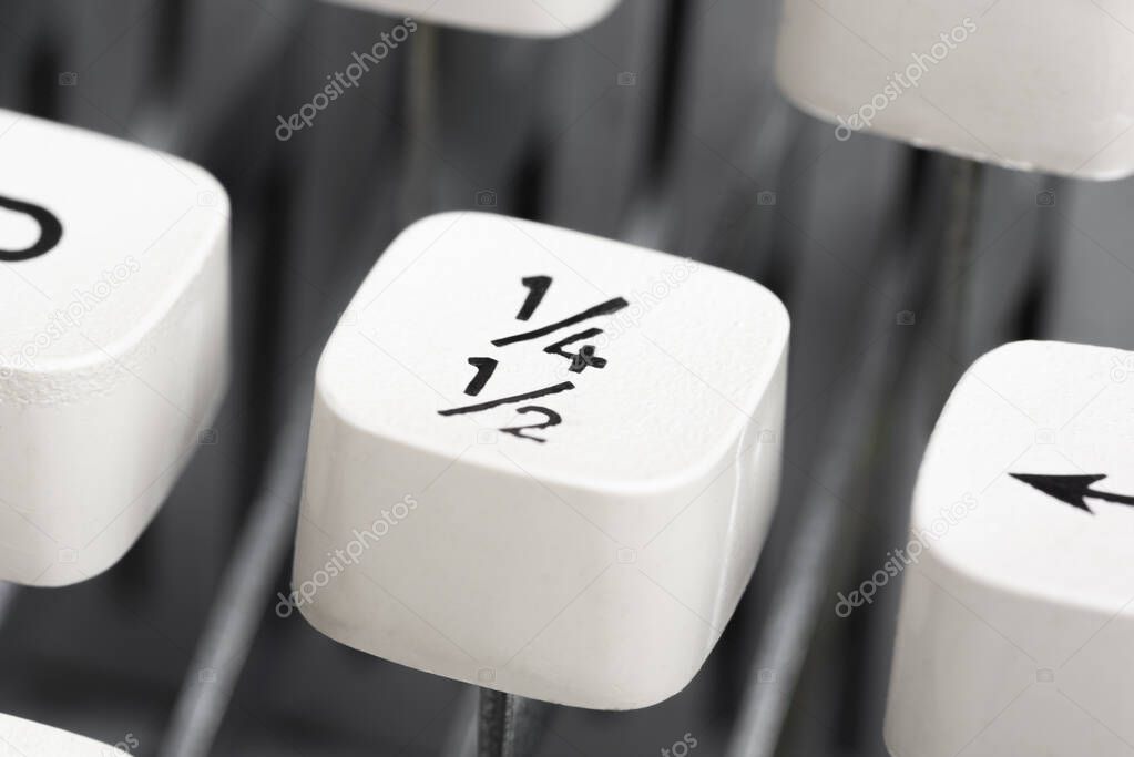 An extreme close-up or macro shot of a plastic keyboard key cap from a manual typewriter with shallow depth of field and selective focus.