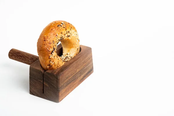 Único Bagel Recém Assado Apoiado Suporte Corte Madeira Definido Fundo — Fotografia de Stock