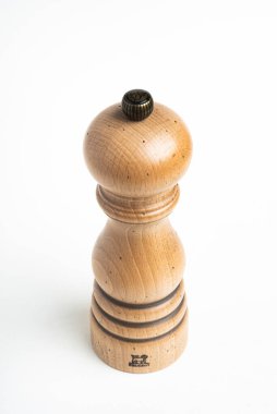 Vidalia, Georgia / USA - May 5, 2020: Studio product shot of the iconic Paris model of the Peugeot pepper mill in natural wood with metal jewel knob. clipart