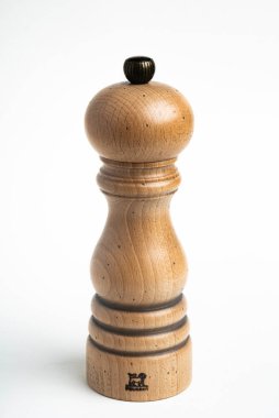 Vidalia, Georgia / USA - May 5, 2020: Studio product shot of the iconic Paris model of the Peugeot pepper mill in natural wood with metal jewel knob. clipart
