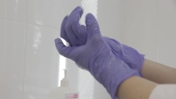 Doctor Disinfects Gloves Examining Patient — Stock Video