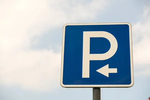 Road sign against the sky. White letter P on a blue background. Sign \