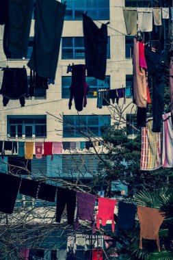 Çamaşırlar çamaşır ipinde asılı duruyor. Şehirdeki evler arasında ipler çekiliyor. Giysiler havayla kurutulmuş. Güneşli. İyi günler. Georgia.