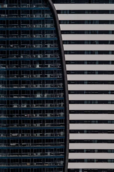 Abstract background with the facade of two buildings. Modern architectural solutions in skyscrapers. Windows and balconies.