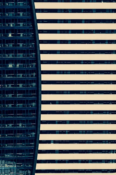 Abstract background with the facade of two buildings. Modern architectural solutions in skyscrapers. Windows and balconies.