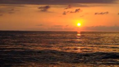 Denizde gün batımı. Kırmızı, sarı gökyüzü. Mavi bulutlar. Güneş suya batıyor. İyi akşamlar. Karadeniz. Georgia.