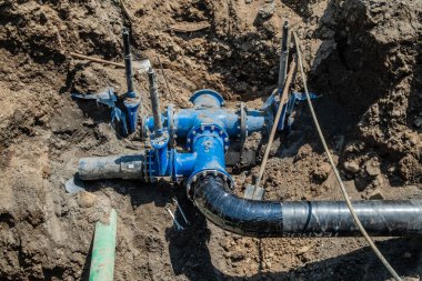 Su dağıtım birimi. Geniş çaplı borular, vanalar, su tankını kapatmak için valfler. - Evet. Toprağa borular döşeyip kum çukurlarıyla doluyor. Şehrin caddesi. İyi günler. Yaz. Georgia.