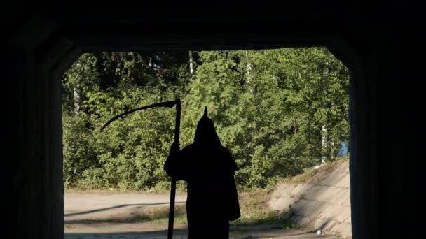 Silhouette of Grim Reaper Walking in the Tunnel