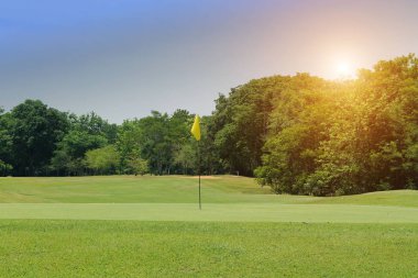 Akşam golf sahasında güneş ışığı var.