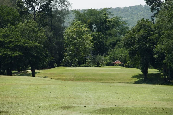 O campo de golfe da noite tem luz solar brilhando no campo de golfe — Fotografia de Stock