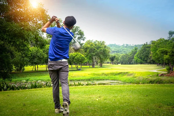 Golfer playing golf on the sand in the evening golf course, on s