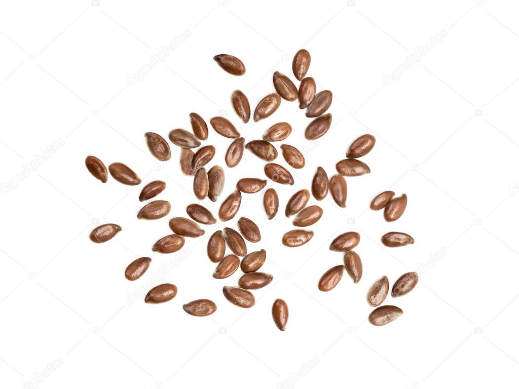 Some linseeds or flax seed spread out on white background seen from above