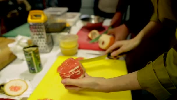 A női kéz a hámozott grapefruitot darabokra vágja. — Stock videók