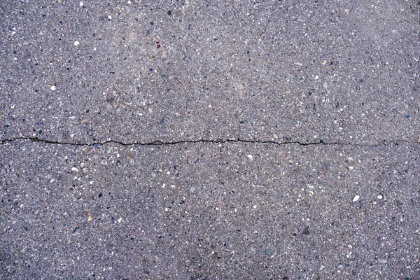 Narrow long crack in asphalt — Stock Photo, Image