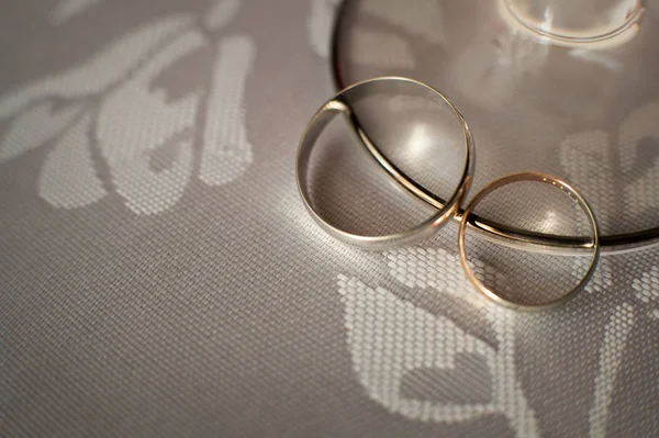 Anéis de casamento de ouro jazem na mesa de close-up — Fotografia de Stock