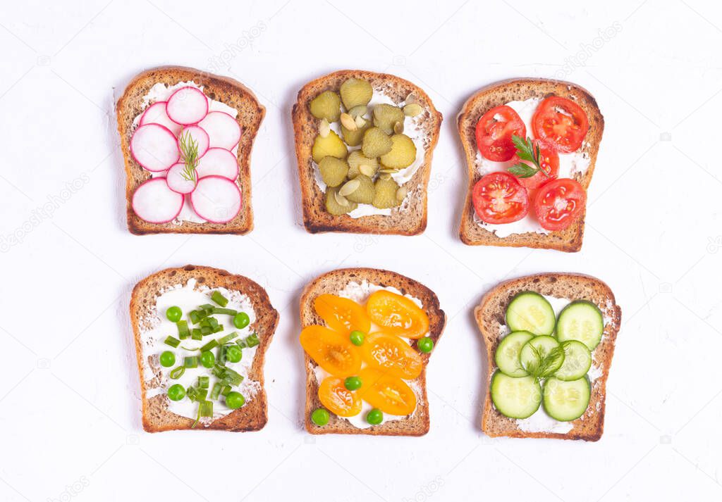 Breakfast sandwiches with vegetable vegetarian toppings on white background