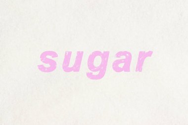 Üzerine beyaz şeker serpiştirilmiş pembe harflerle yazılmış.