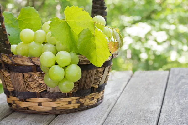 Closeup Fresh Green Grapes Rustic Basket Weathered Wooden Surface — Stock Photo, Image