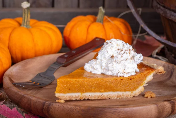 Nahaufnahme Einer Scheibe Kürbiskuchen Mit Schlagsahnebelag Und Kürbissen Hintergrund Ländlicher — Stockfoto