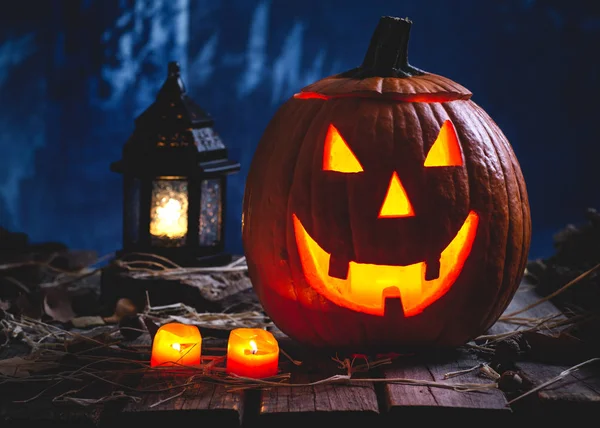 Glowing Jack-O-Lantern With Burning Candles and Lantern