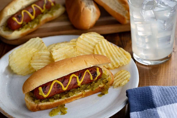 Grilled Hot Dog Mustard Relish Bun Potato Chips White Plate — Stock Photo, Image