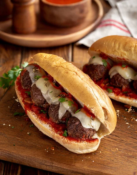 Meatball sandwich with tomato sauce and cheese on a hoagie roll