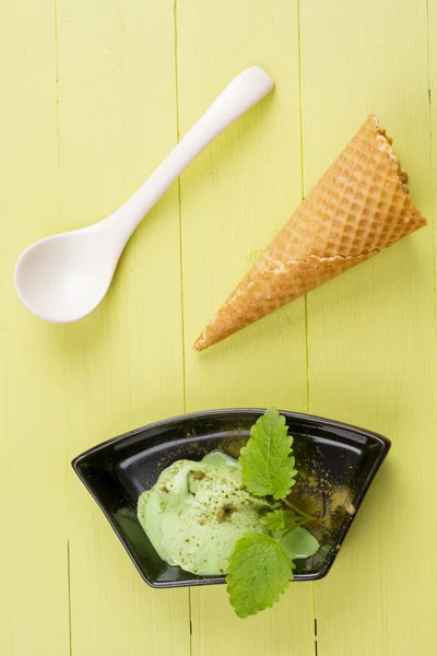 Green tea ice cream on wooden table