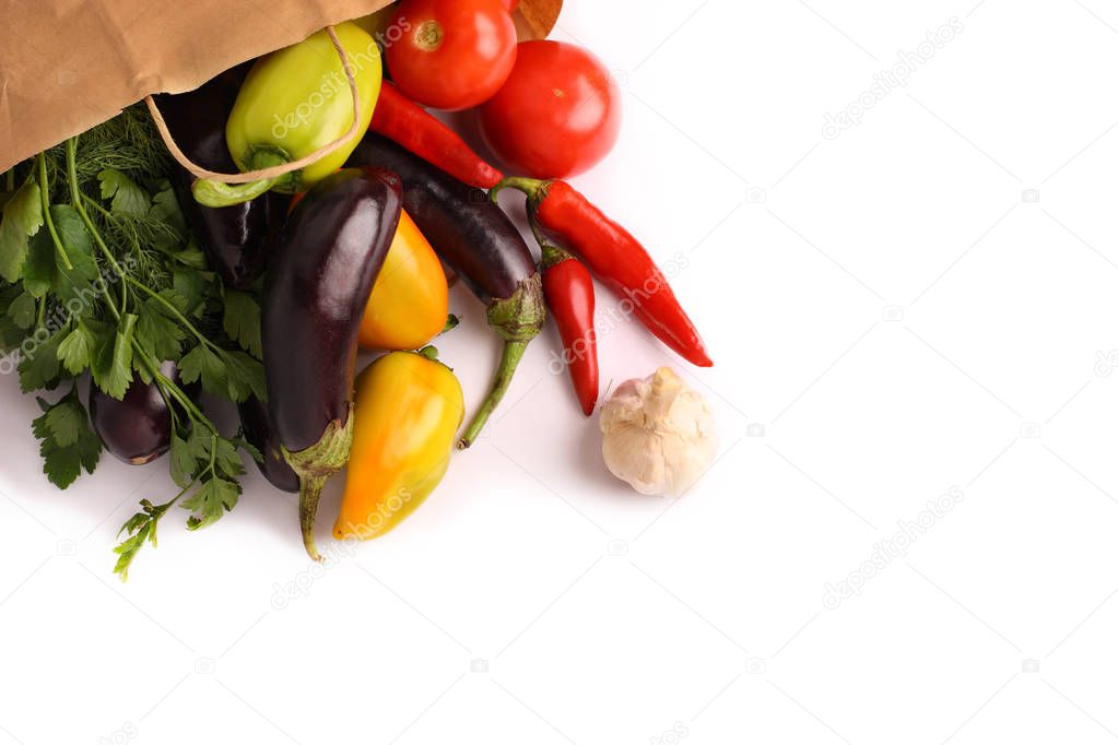 Fresh vegetables, autumn harvest in a paper bag. Healthy eating. Isolated on a white background.