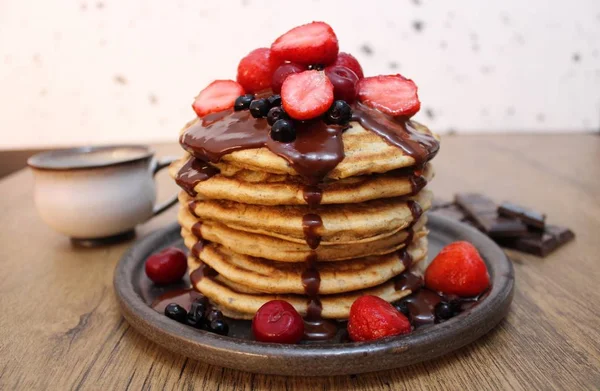 Delicious Pancakes covered with chocolate and fruits ready to be enjoyed on a Sunday morning!