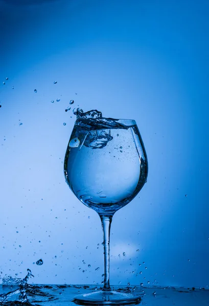 water, glass, drink, splash, liquid, pouring, blue, isolated, drop, white, beverage, fresh, cold, alcohol, clear, splashing, wine, object, clean, bubble, transparent, pour, cocktail, ice,