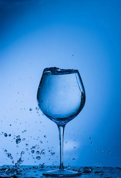 water, glass, drink, splash, liquid, pouring, blue, isolated, drop, white, beverage, fresh, cold, alcohol, clear, splashing, wine, object, clean, bubble, transparent, pour, cocktail, ice,